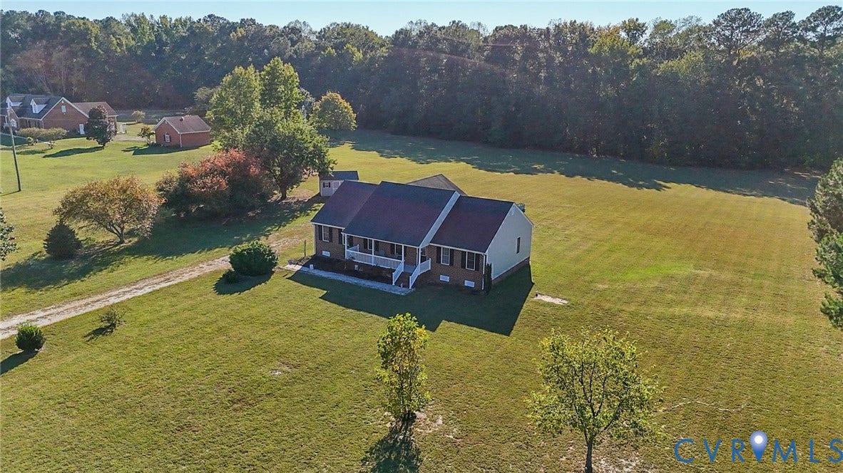 20550 Horseshoe Road, Prince George, VA 23830 Expansive grass lawn with a traditional-style residence featuring a covered front porch and dormer windows