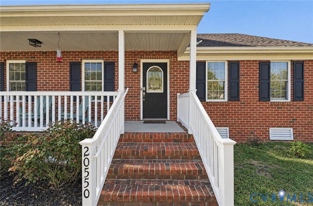 20550 Horseshoe Road, Prince George, VA 23830 Brick exterior with white trim, covered front porch, brick steps with white railings, and a black entry door with an arched glass insert