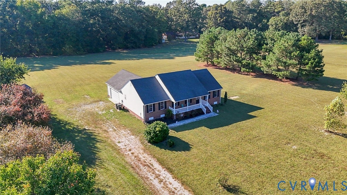 20550 Horseshoe Road, Prince George, VA 23830 Brick exterior with white trim, covered front porch, and a gravel driveway