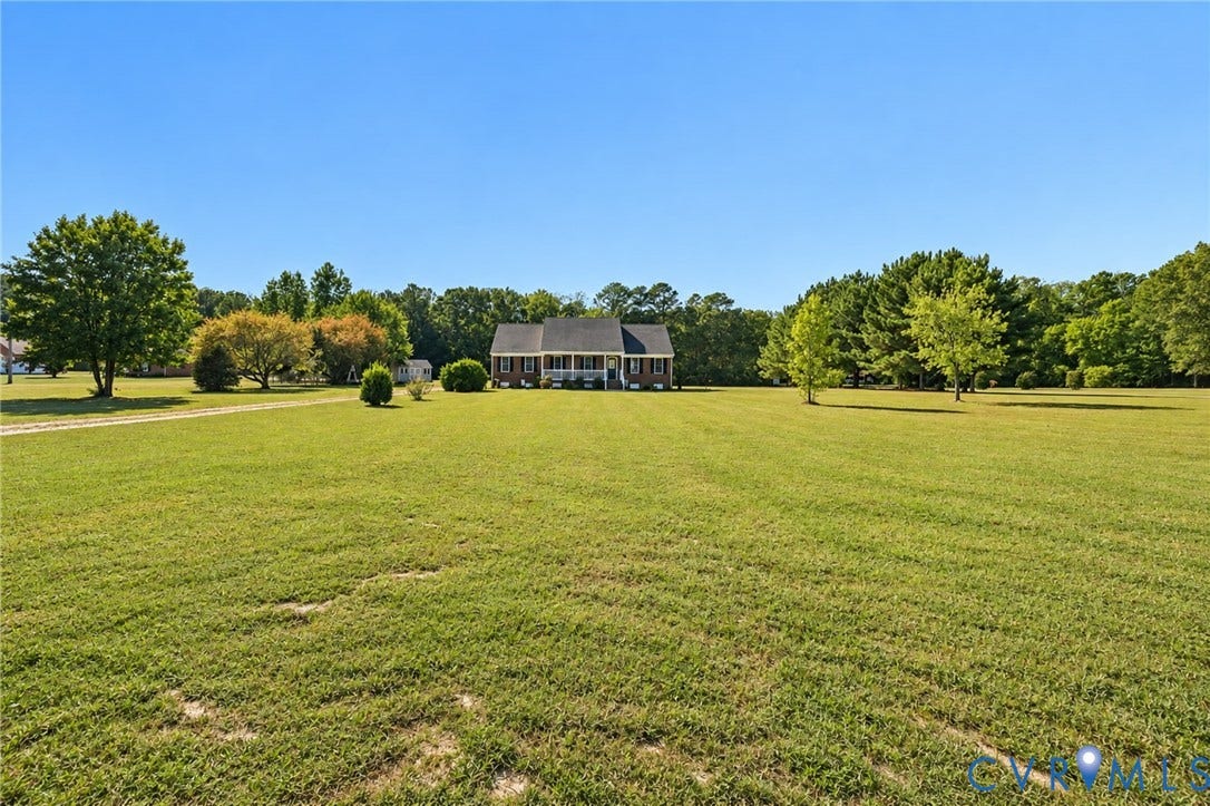 20550 Horseshoe Road, Prince George, VA 23830 Expansive lawn with mature trees, a gravel driveway, and a white-columned front porch