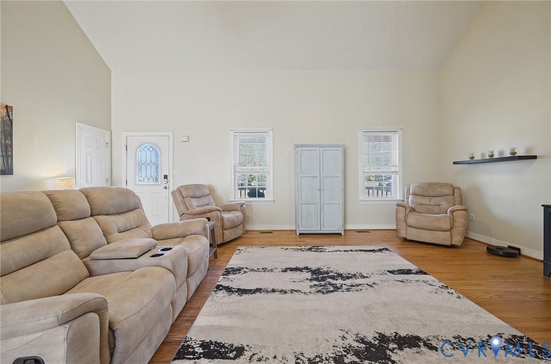 20550 Horseshoe Road, Prince George, VA 23830 Vaulted ceilings, wood-finish flooring, white walls, multiple windows, and a decorative front entry door with a glass insert
