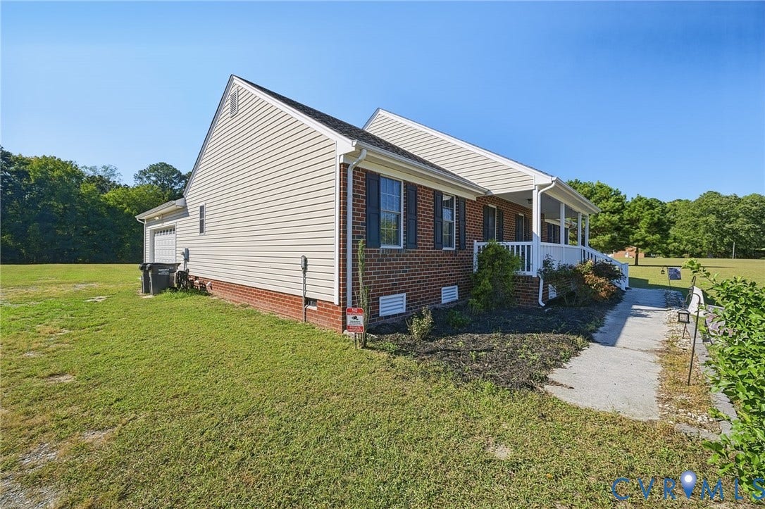 20550 Horseshoe Road, Prince George, VA 23830 Exterior featuring brick and siding construction, covered porch, and attached garage