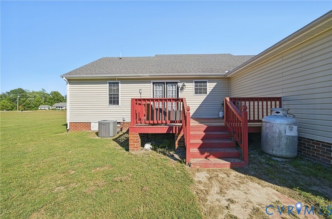 20550 Horseshoe Road, Prince George, VA 23830 Exterior with neutral-toned siding, a red-painted wooden deck, and a gray shingle roof
