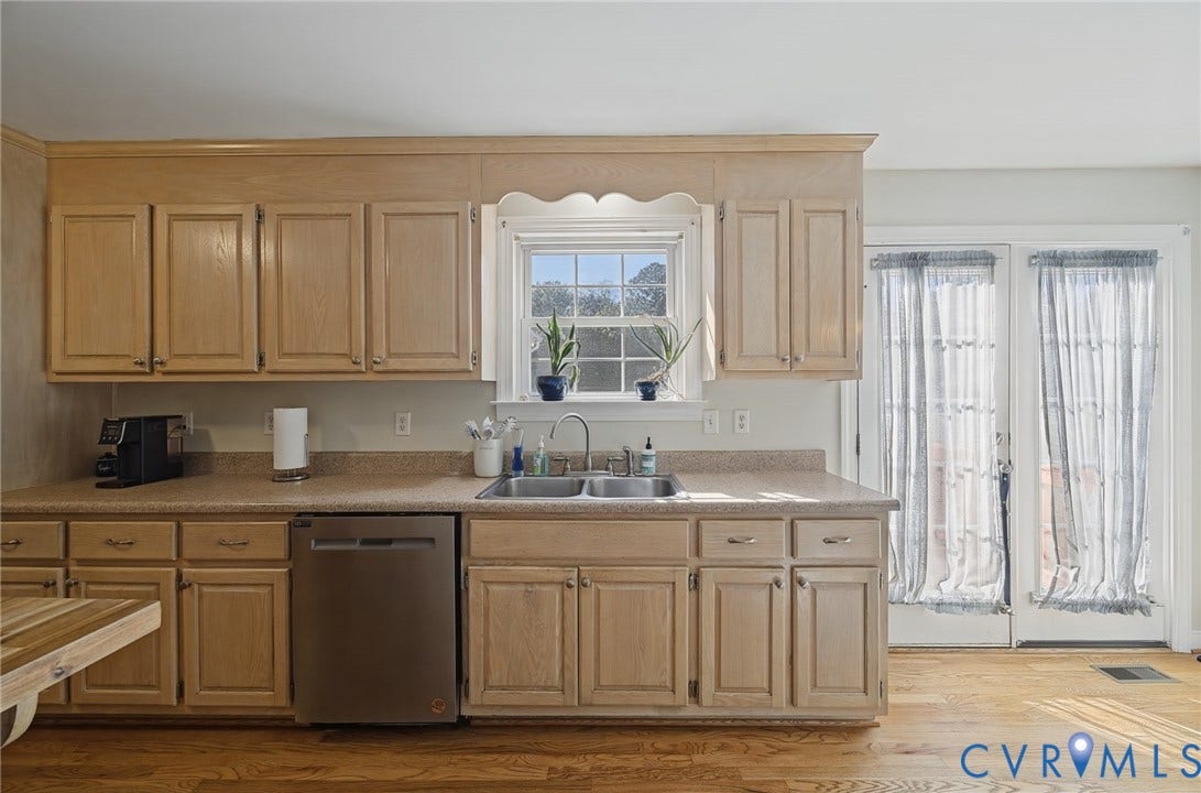 20550 Horseshoe Road, Prince George, VA 23830 Wood-finish cabinetry, stainless steel dishwasher, double basin sink, and a window above the sink