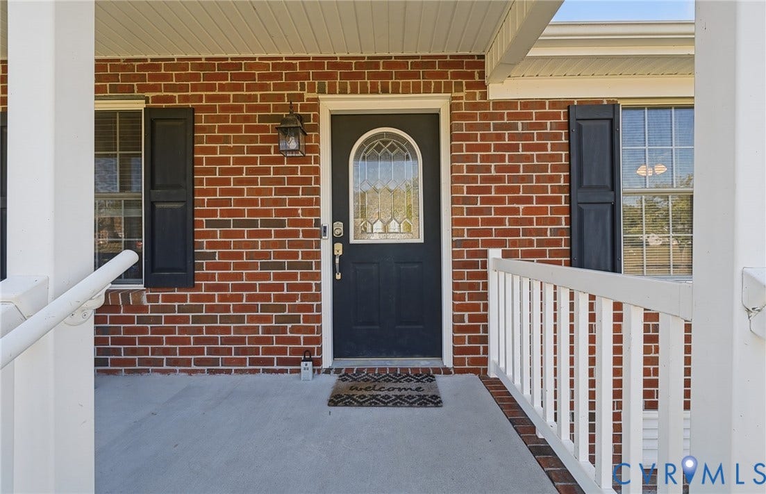 20550 Horseshoe Road, Prince George, VA 23830 Brick exterior with white trim, a dark-colored entry door with decorative glass, and a covered porch