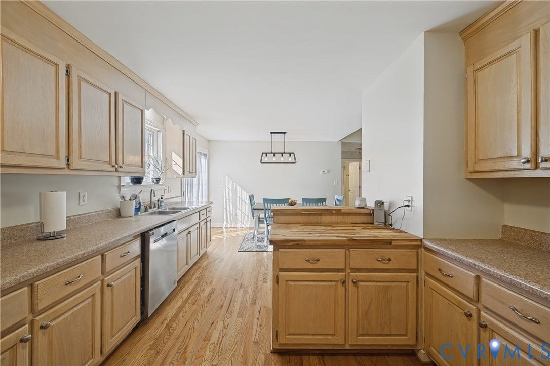 20550 Horseshoe Road, Prince George, VA 23830 Kitchen featuring wood-finish cabinetry, stainless steel dishwasher, double basin sink, and wood-finish flooring