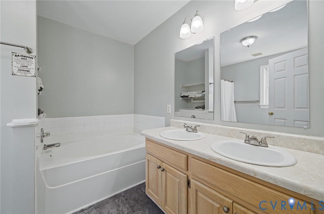 20550 Horseshoe Road, Prince George, VA 23830 Dual vanity with light wood-finish cabinetry and individual mirrors