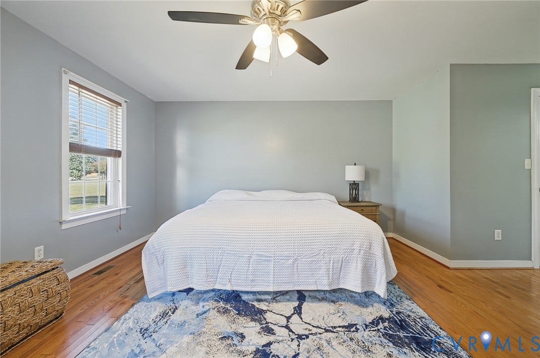 20550 Horseshoe Road, Prince George, VA 23830 Hardwood flooring, light gray walls, white trim, ceiling fan with light fixture, and a window with blinds