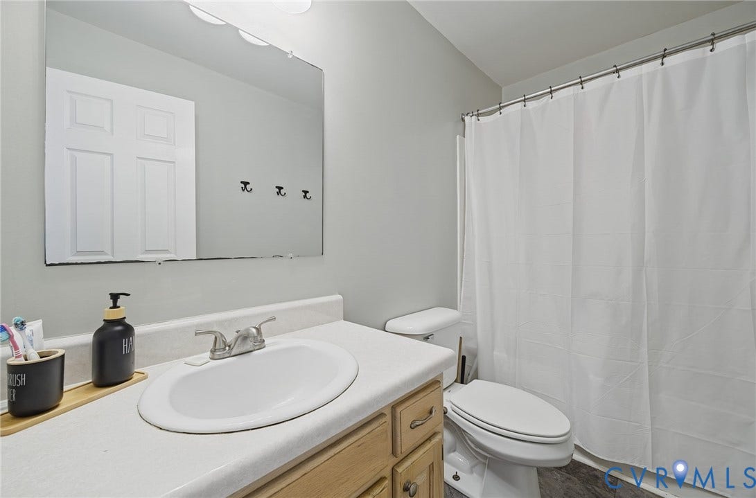20550 Horseshoe Road, Prince George, VA 23830 Vanity with wood-finish cabinetry, integrated sink, and dual-handle faucet