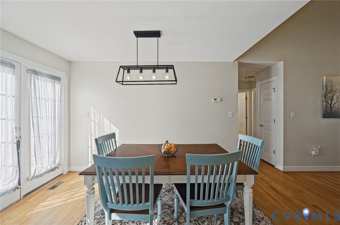 20550 Horseshoe Road, Prince George, VA 23830 Hardwood flooring, white double French doors, contemporary linear chandelier, and a vaulted ceiling