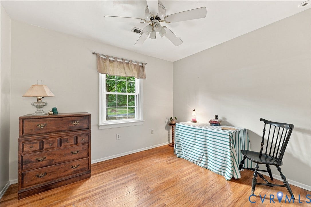 Hardwood-style flooring, a multi-pane window, and a ceiling fan