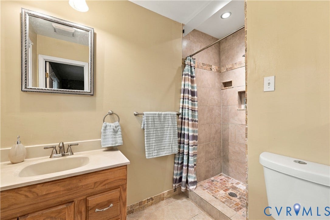 Wood-finish vanity with an integrated sink and chrome faucet