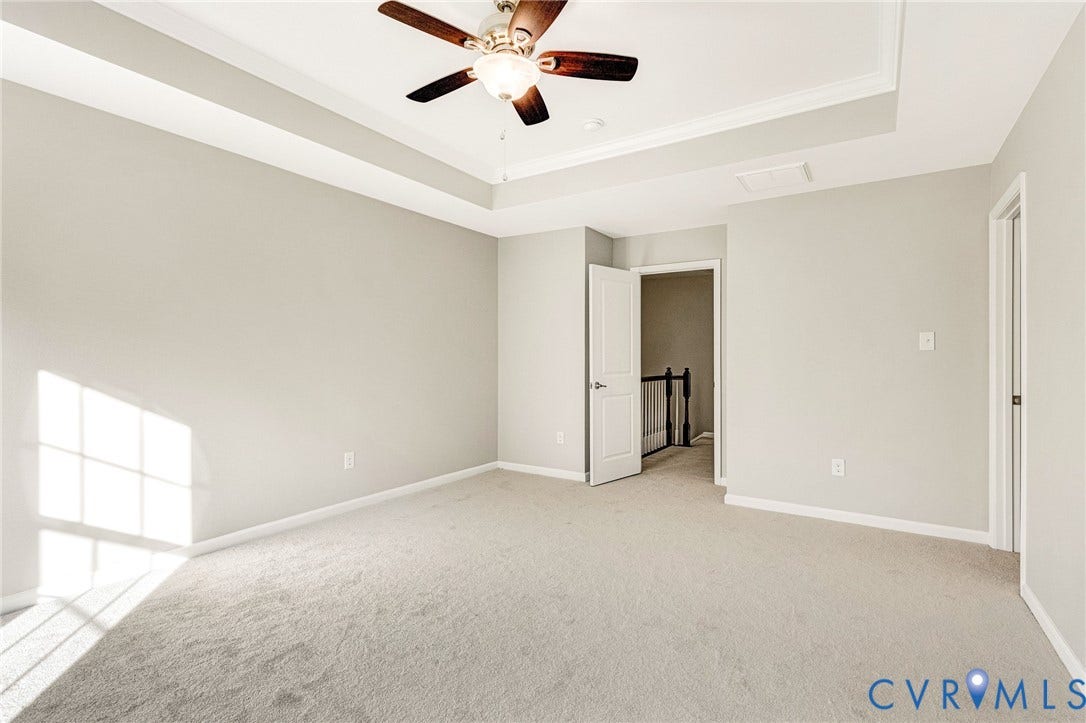 8926 Ringview Drive, Mechanicsville, VA 23116 Recessed tray ceiling with a built-in ceiling fan, light gray wall paint, and light-colored carpeting
