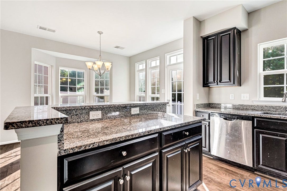 8926 Ringview Drive, Mechanicsville, VA 23116 Kitchen featuring dark wood cabinetry, stainless steel dishwasher, granite countertops, and wood-finish flooring
