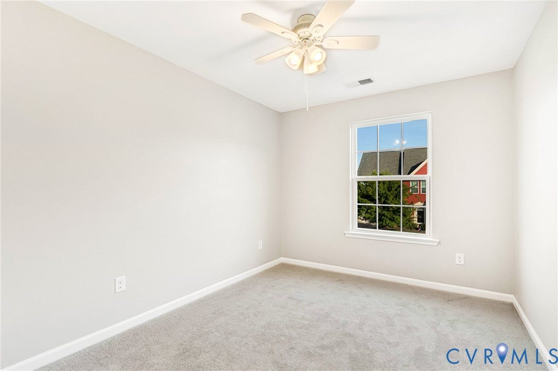 8926 Ringview Drive, Mechanicsville, VA 23116 Recessed window with white trim, light gray wall paint, light gray carpet, and a white ceiling fan with integrated lighting