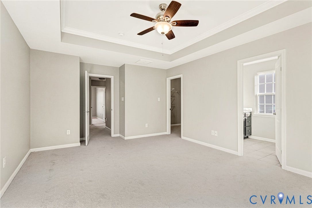 8926 Ringview Drive, Mechanicsville, VA 23116 Tray ceiling with crown molding, ceiling fan with integrated lighting, light gray wall paint, and light gray carpet flooring