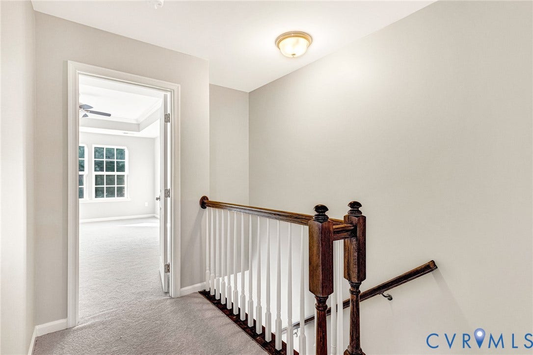 8926 Ringview Drive, Mechanicsville, VA 23116 Hallway with carpeting and a wood-finish railing