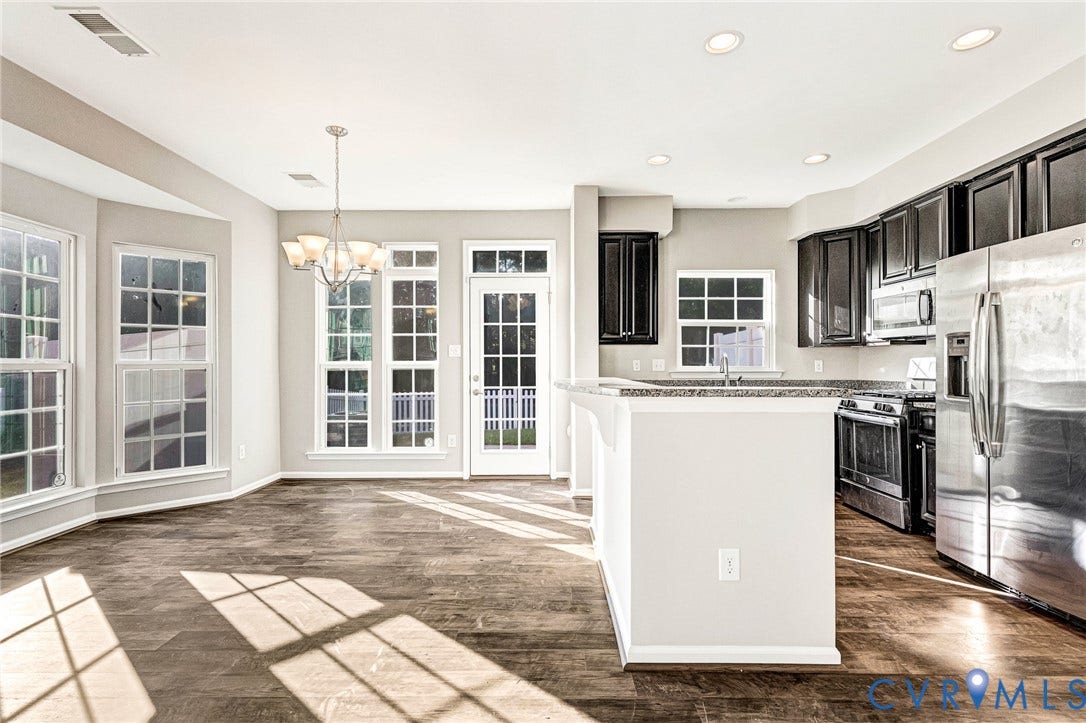 8926 Ringview Drive, Mechanicsville, VA 23116 Open-concept living space featuring wood-finish flooring, recessed lighting, and a chandelier