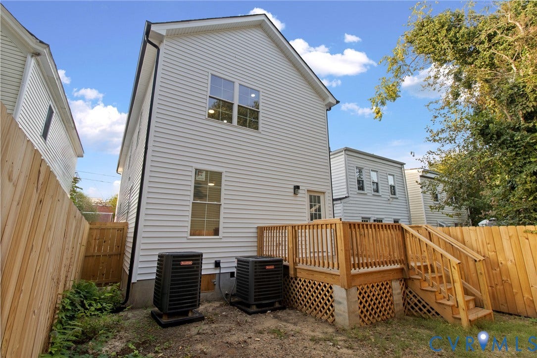 Newly constructed rear deck with wood railing and lattice skirting