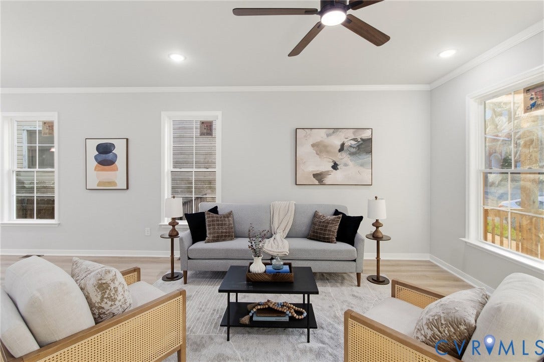 Bright living area featuring wood-finish flooring, recessed lighting, and a ceiling fan