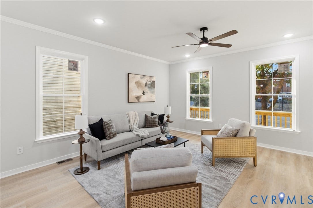 Light-colored wood-finish flooring, crisp white walls, recessed lighting, crown molding, and a ceiling fan with integrated lighting