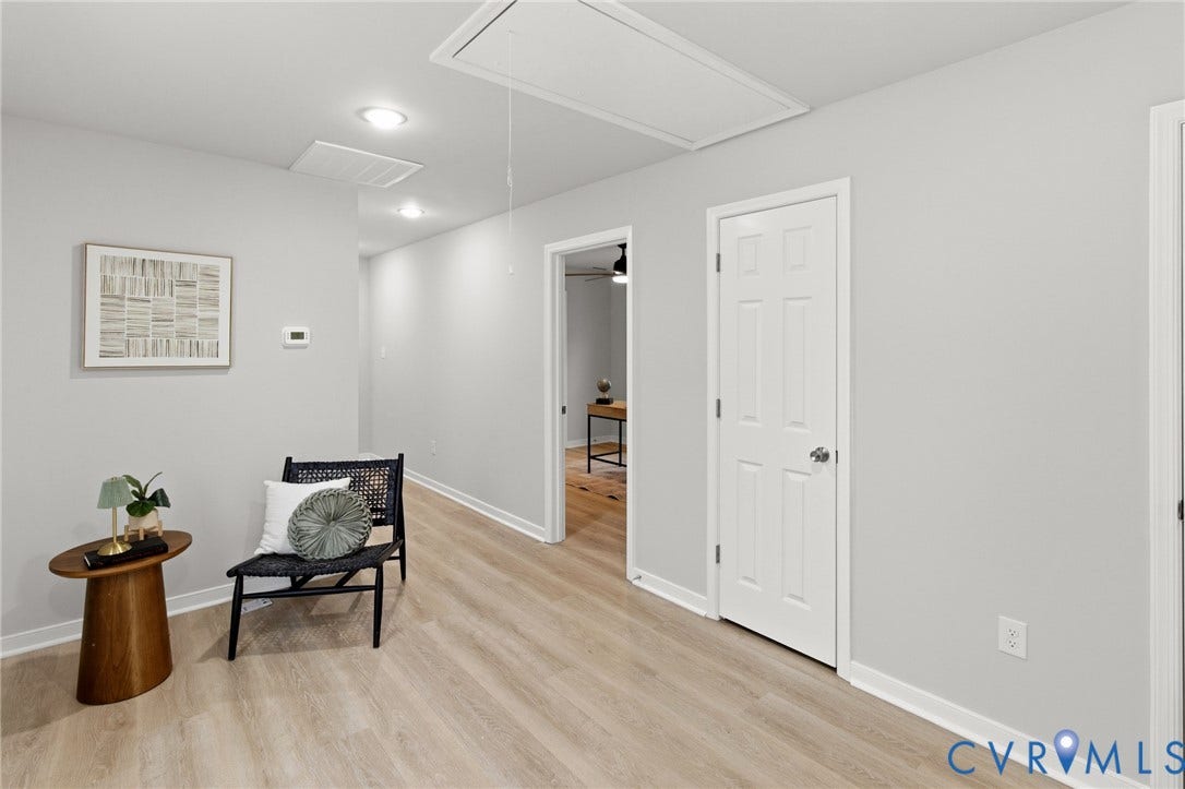 Light wood-finish flooring, recessed lighting, and crisp white trim