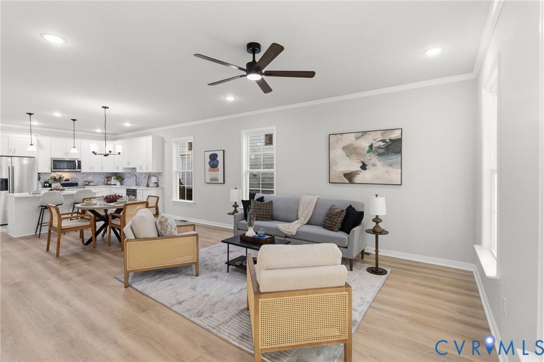 Open-concept living space featuring wood-finish flooring, recessed lighting, and a ceiling fan