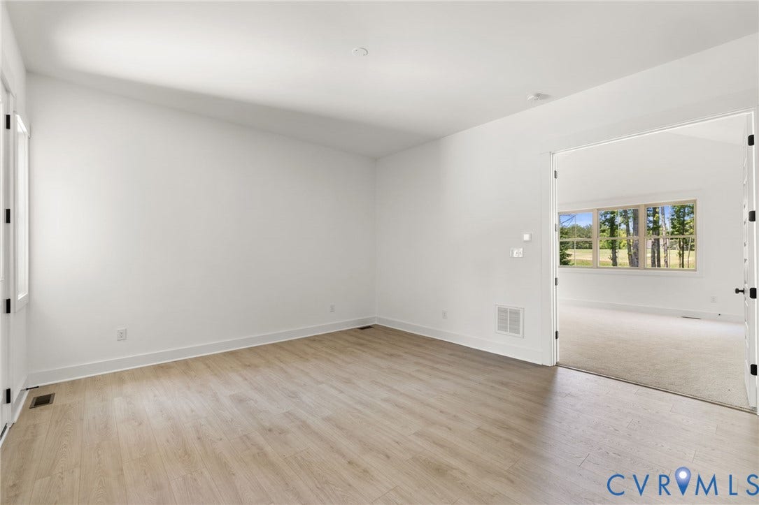 9514 Angels Share Drive, New Kent, VA 23141 Spacious room with wood-finish flooring, recessed ceiling lighting, and crisp white walls