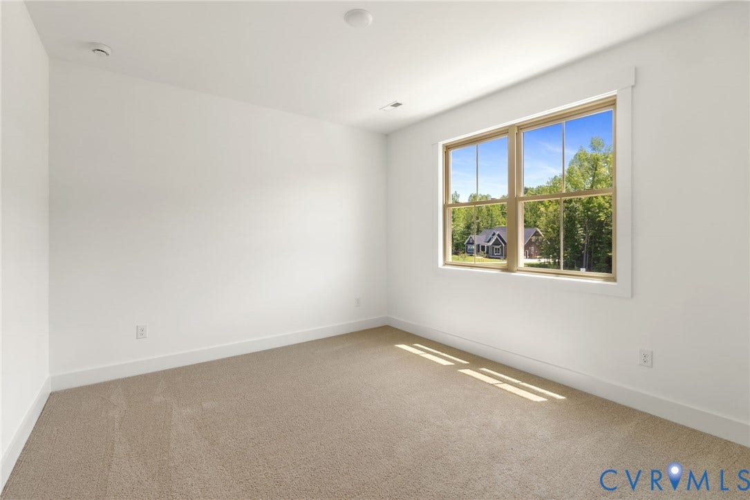 9514 Angels Share Drive, New Kent, VA 23141 Neutral-toned carpet flooring, white walls, recessed ceiling lighting, and a window with wood-finish framing