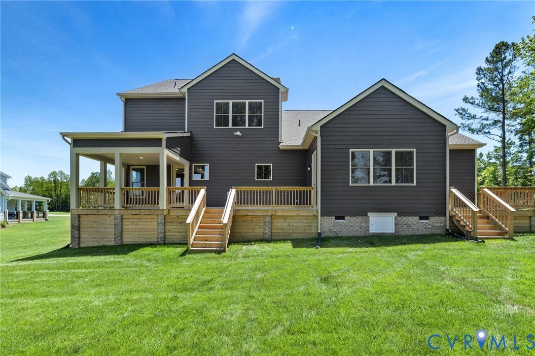 9514 Angels Share Drive, New Kent, VA 23141 Expansive backyard with a covered patio, multiple outdoor decks, and dual wooden staircases