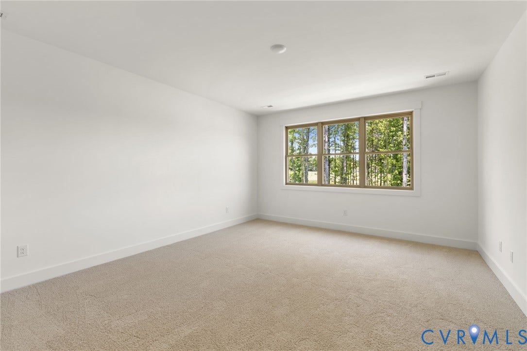 9514 Angels Share Drive, New Kent, VA 23141 Neutral wall color, recessed lighting, and a large window with natural wood-tone trim