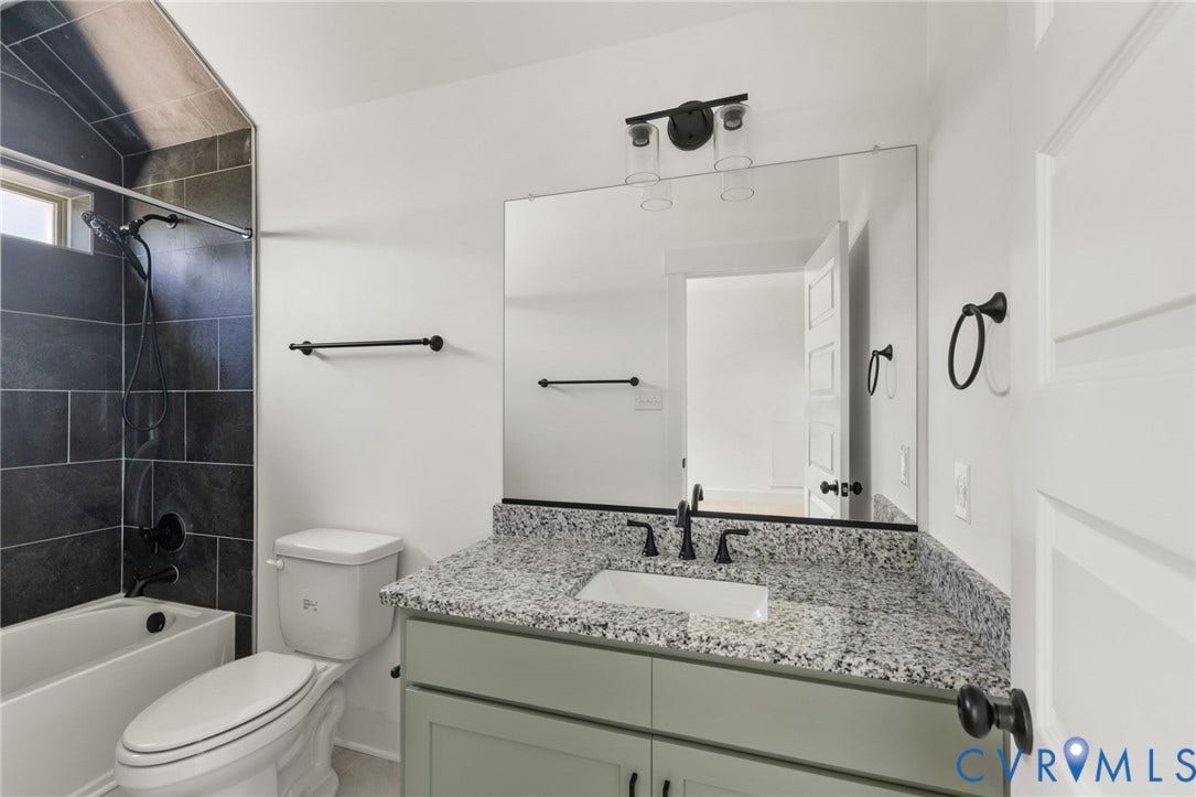 9514 Angels Share Drive, New Kent, VA 23141 Bathtub with dark subway tile surround, matte black fixtures, and a window
