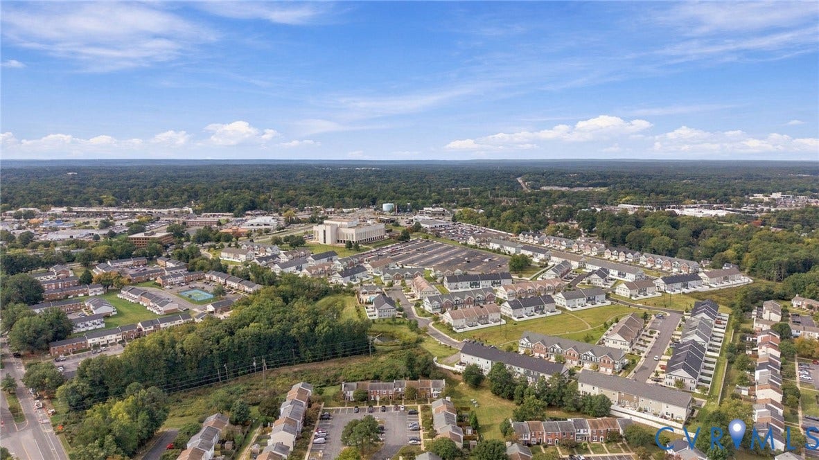 8434 Shannon Green Court, Henrico, VA 23228 Expansive residential area featuring a mix of housing styles, abundant mature trees, and clear blue skies