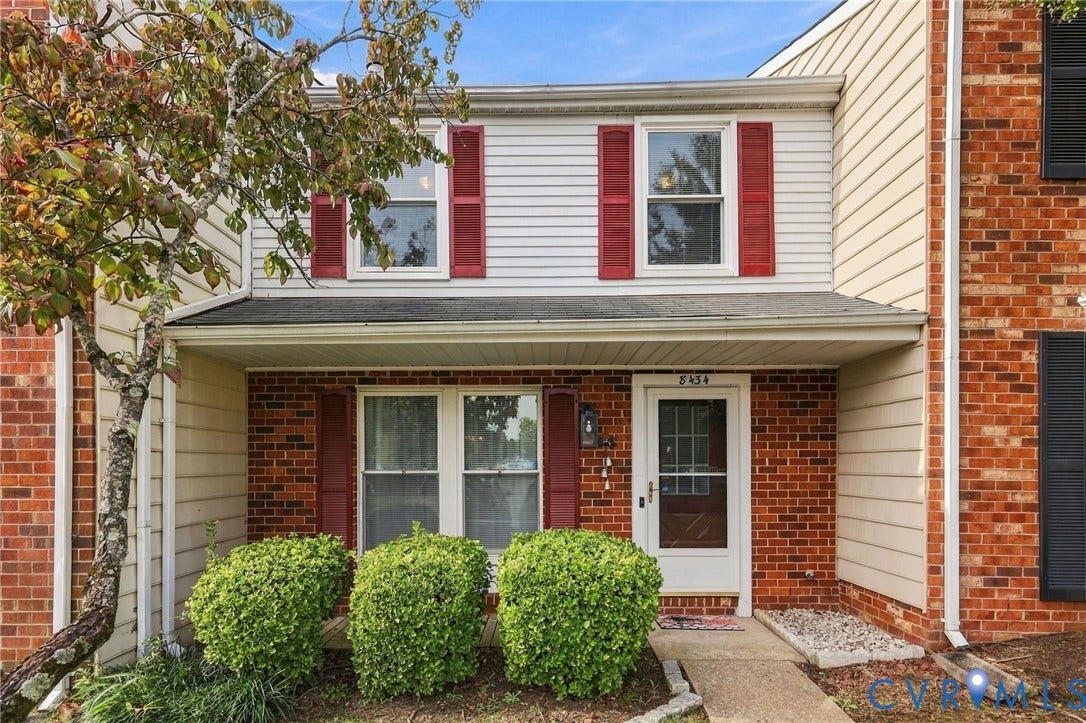 8434 Shannon Green Court, Henrico, VA 23228 Brick and siding exterior with red shutters, covered entryway, and mature landscaping