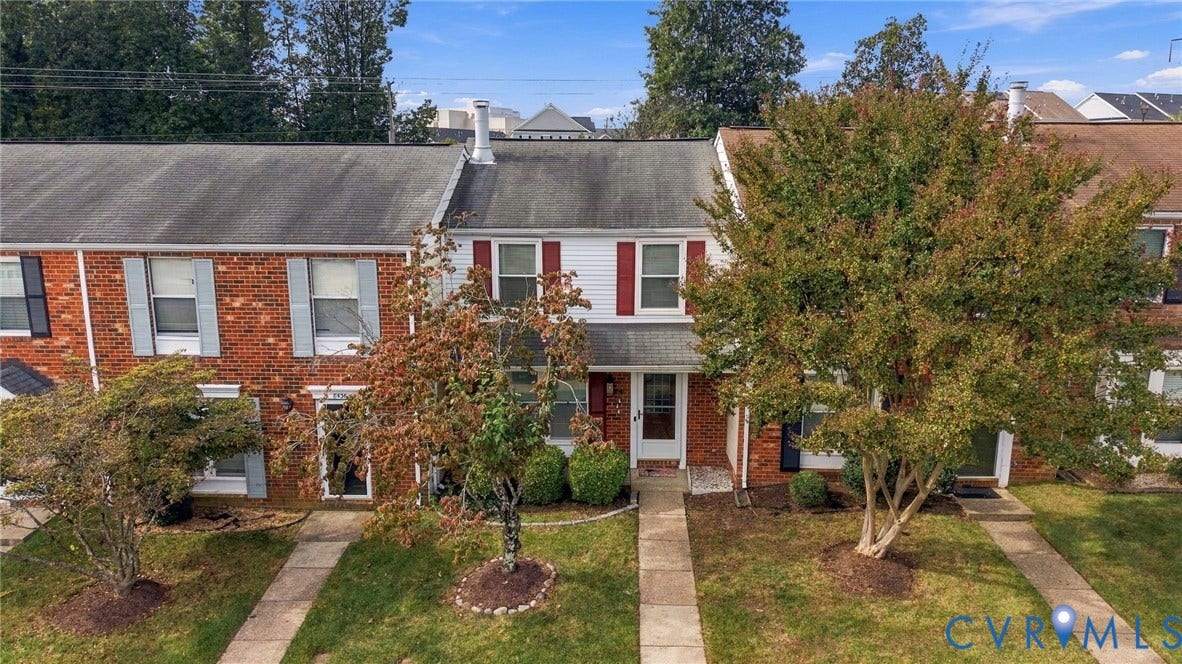 8434 Shannon Green Court, Henrico, VA 23228 Brick facade with white siding, red window shutters, mature trees, manicured lawn, and concrete walkways