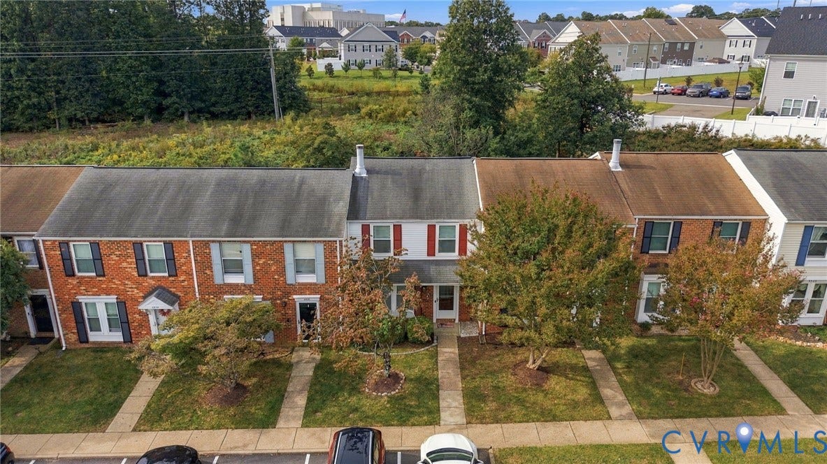 8434 Shannon Green Court, Henrico, VA 23228 Brick facade with contrasting shutters, individual front walkways, and a manicured lawn