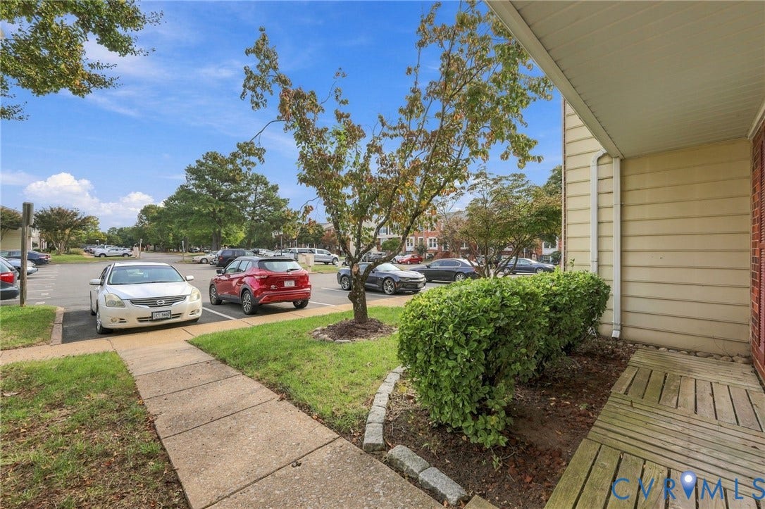 8434 Shannon Green Court, Henrico, VA 23228 Siding exterior with a covered entry and wood-slat flooring