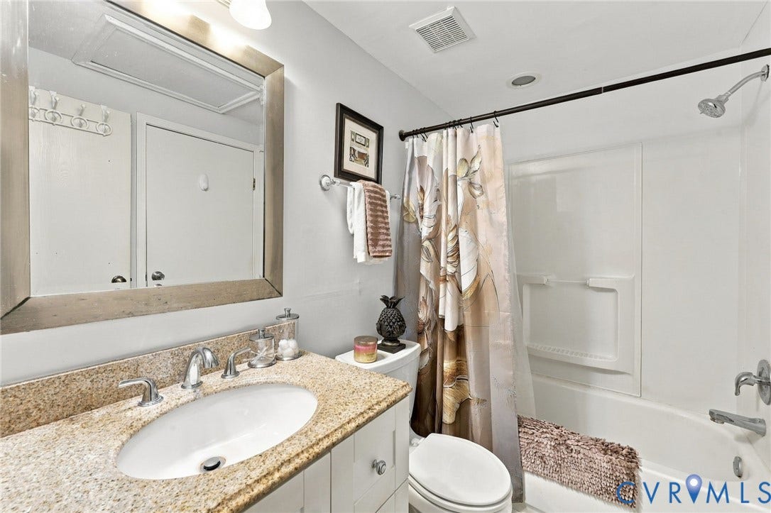 8434 Shannon Green Court, Henrico, VA 23228 Bathroom featuring a white vanity with an oval undermount sink, a chrome-finish faucet, and a stone-finish countertop