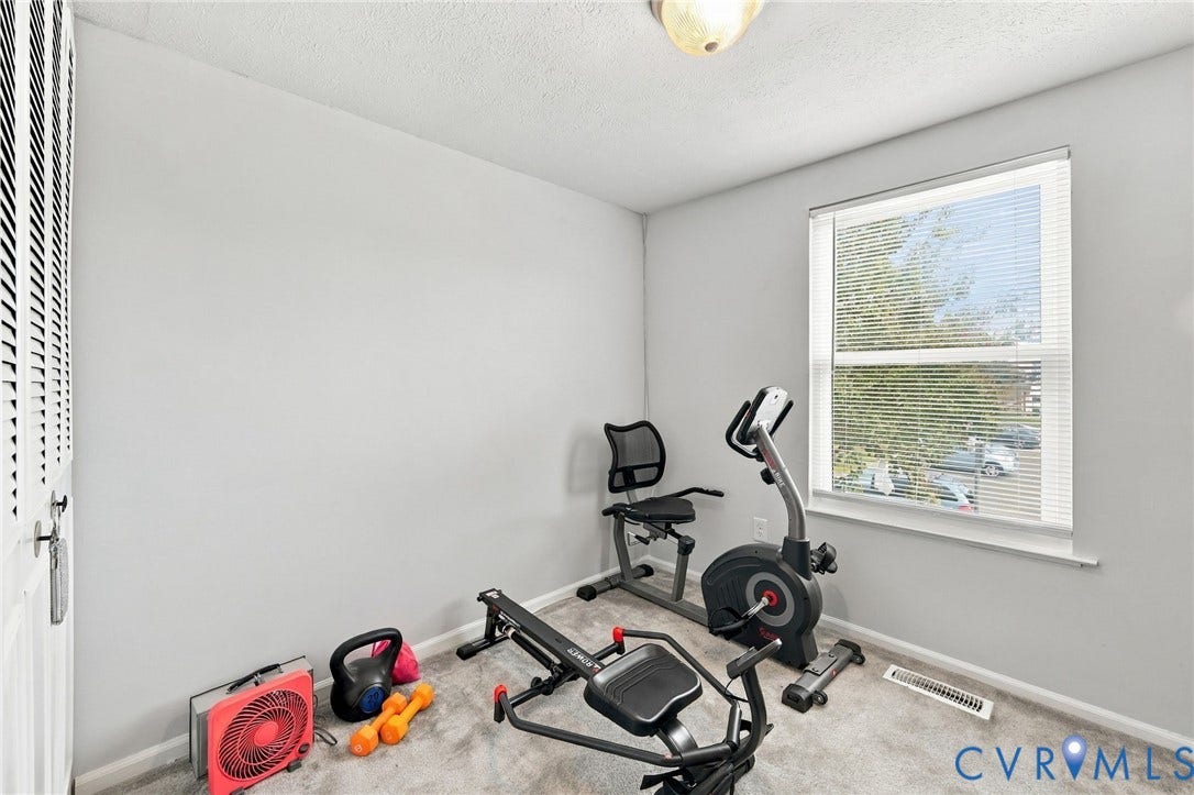 8434 Shannon Green Court, Henrico, VA 23228 Room featuring light gray walls, a window with blinds, and light-colored carpeting