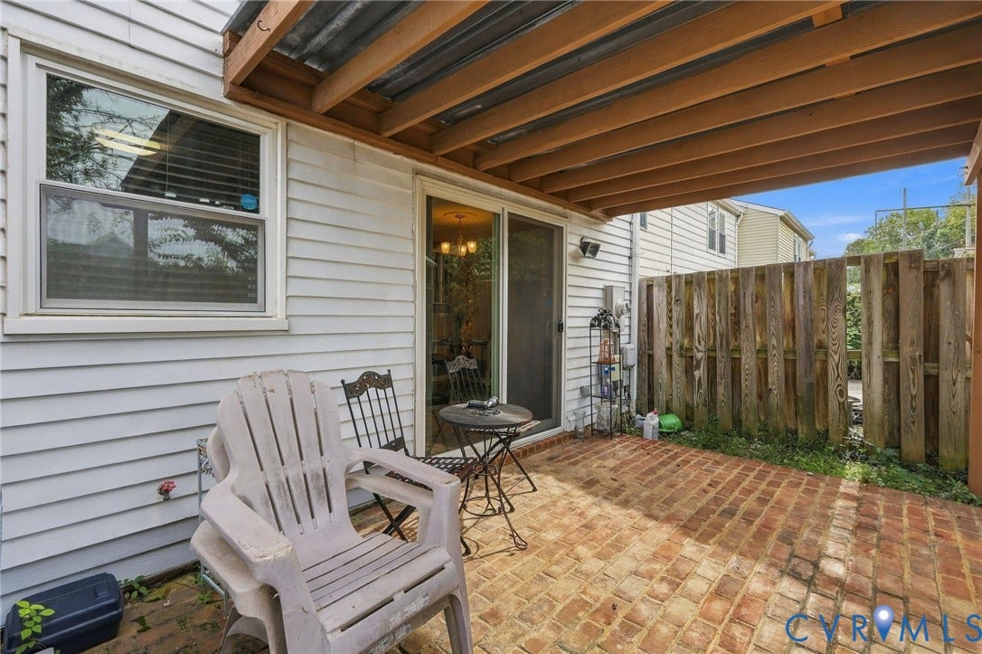 8434 Shannon Green Court, Henrico, VA 23228 Brick paver patio with a wood privacy fence and covered overhead structure