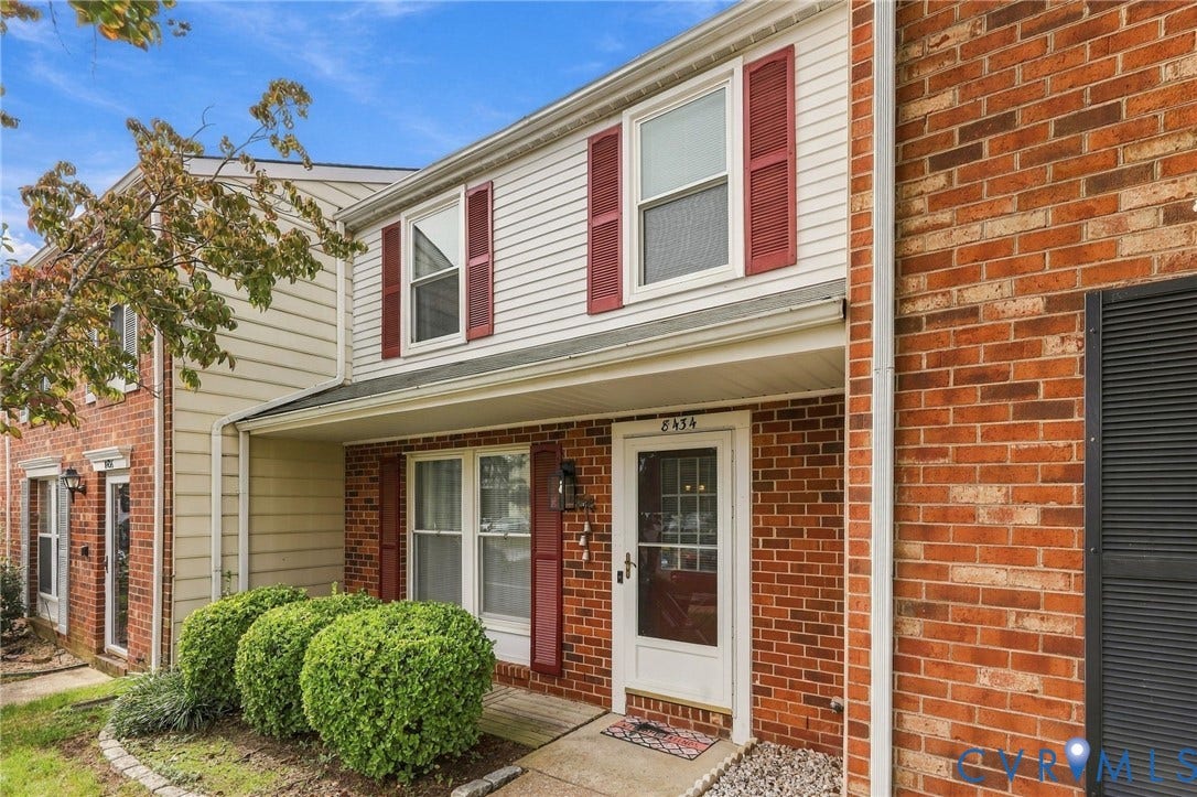8434 Shannon Green Court, Henrico, VA 23228 Brick and siding exterior with red shutters, covered entry, and a concrete walkway