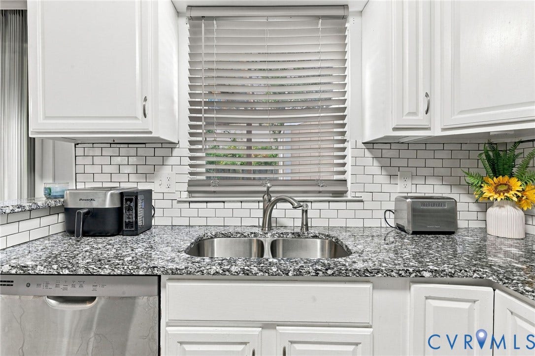 8434 Shannon Green Court, Henrico, VA 23228 White cabinetry, subway tile backsplash, dual basin stainless steel sink, stainless steel dishwasher, and mottled countertop