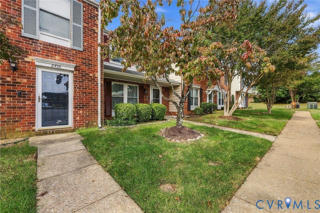 8434 Shannon Green Court, Henrico, VA 23228 Brick exterior with a storm door entry and upper-level window with shutters