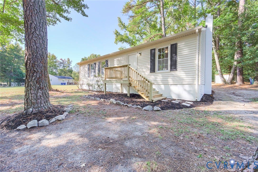 21108 Matoaca Road, Chesterfield, VA 23803 Single-story home featuring light-colored siding, a front porch with wooden steps, and dark window shutters