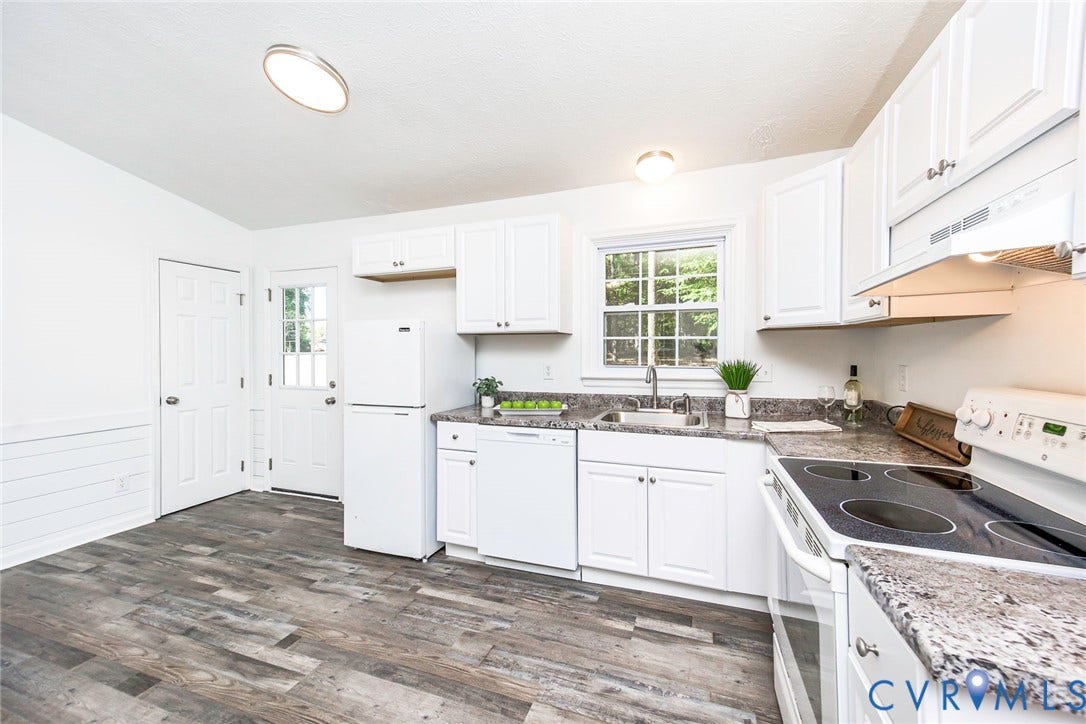 21108 Matoaca Road, Chesterfield, VA 23803 White cabinetry, dark stone-finish countertops, wood-finish flooring, and white appliances