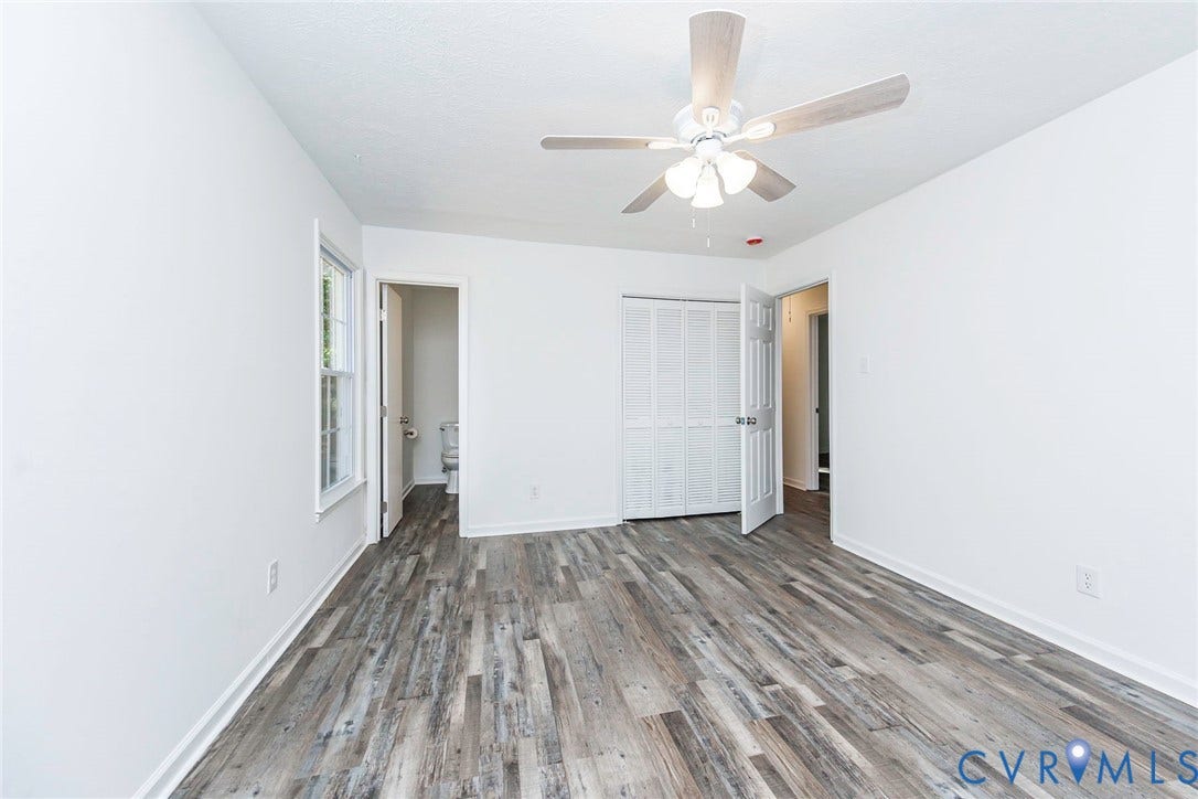 21108 Matoaca Road, Chesterfield, VA 23803 Wood-finish flooring, white walls, ceiling fan with integrated lighting, window with white trim, and bi-fold closet doors
