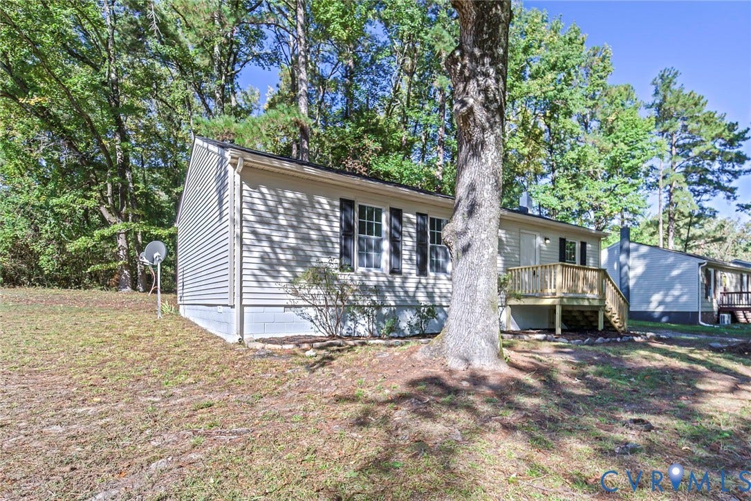 21108 Matoaca Road, Chesterfield, VA 23803 Light-colored siding exterior, dark window shutters, and a rear wood deck with steps
