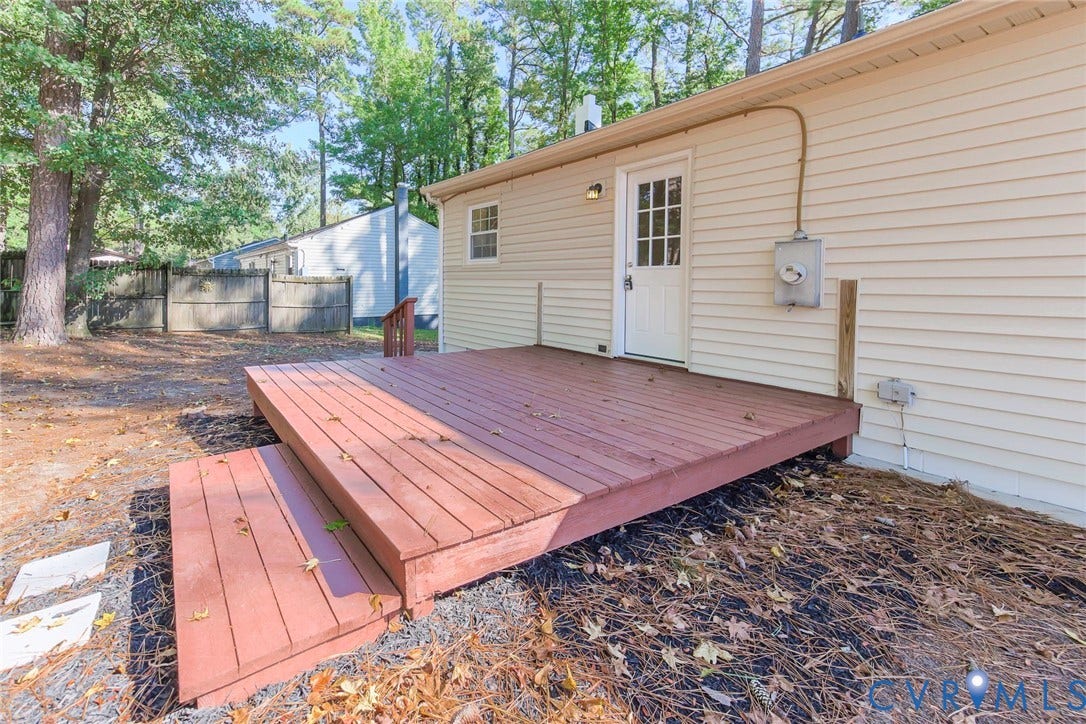 21108 Matoaca Road, Chesterfield, VA 23803 Expansive wooden deck with two steps, durable vinyl siding, and exterior wall lighting