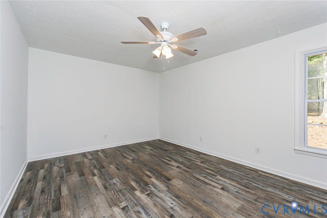 21108 Matoaca Road, Chesterfield, VA 23803 Wood-finish flooring, white walls, white ceiling fan with integrated lighting, and a white-framed window