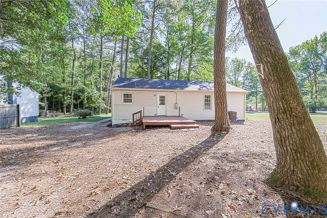 21108 Matoaca Road, Chesterfield, VA 23803 Rear exterior with a wood-tone deck, white siding, and mature trees